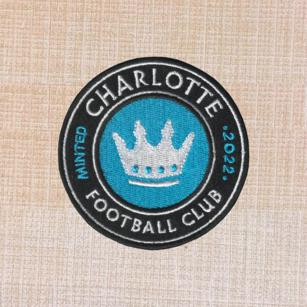 Charlotte Football Club embroidered logo patch with crown in blue, black, and white.