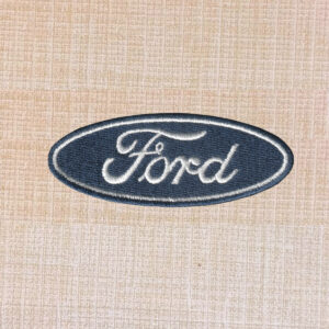 Blue and white Ford logo embroidered iron-on patch with oval design.