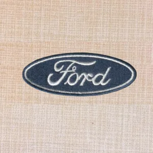 Blue and white Ford logo embroidered iron-on patch with oval design.