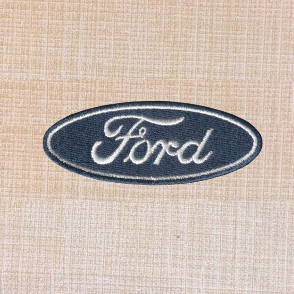 Blue and white Ford logo embroidered iron-on patch with oval design.