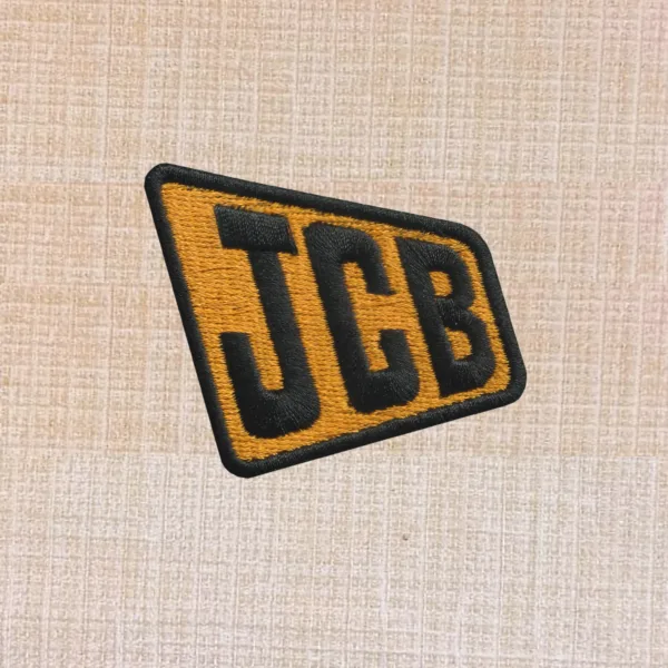 JCB logo embroidered iron-on patch in yellow and black for workwear or accessories.