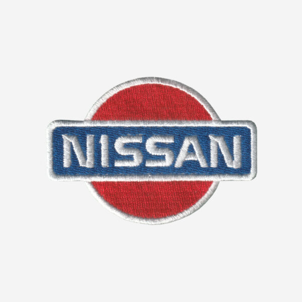 Nissan Logo Embroidered Iron On Patch Nissan logo embroidered iron-on patch in silver, black, and red for automotive apparel.